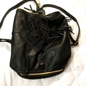 Black leather backpack no name leather straps tastles on the front